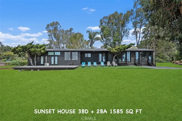 a view of a house with backyard porch and sitting area