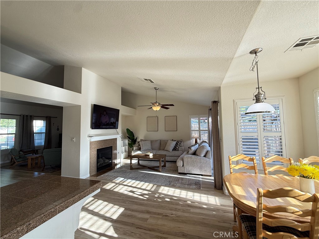 2709 Big Sandy Avenue Merced, CA 95348 - Photo 12 of 51 a living room with furniture a fireplace and a flat screen tv