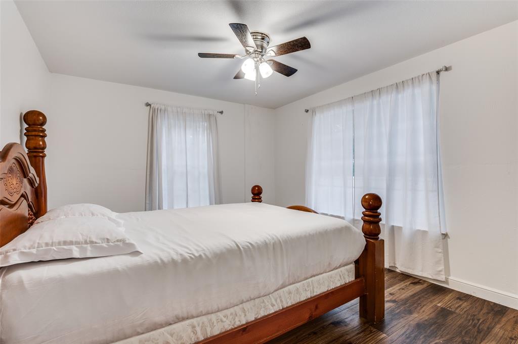 606 Quiram Lane Kemp, TX 75143 - Photo 15 of 23 a bedroom with a bed and a chandelier