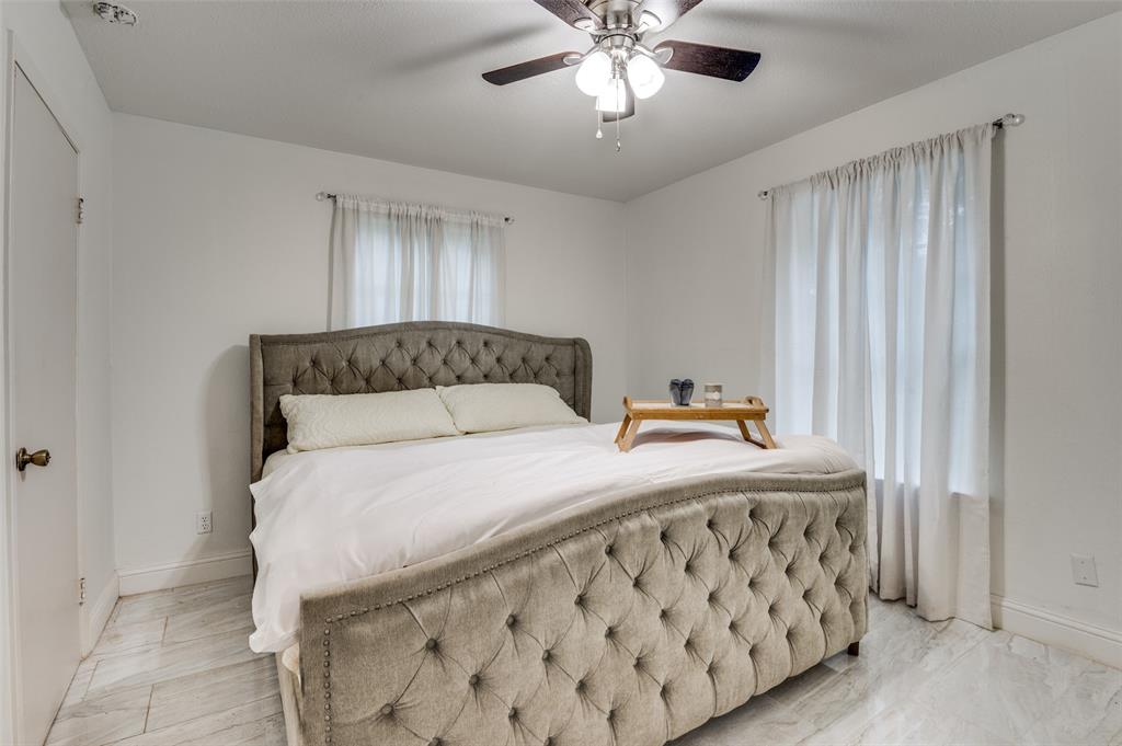 606 Quiram Lane Kemp, TX 75143 - Photo 17 of 23 a bedroom with a bed and a chandelier