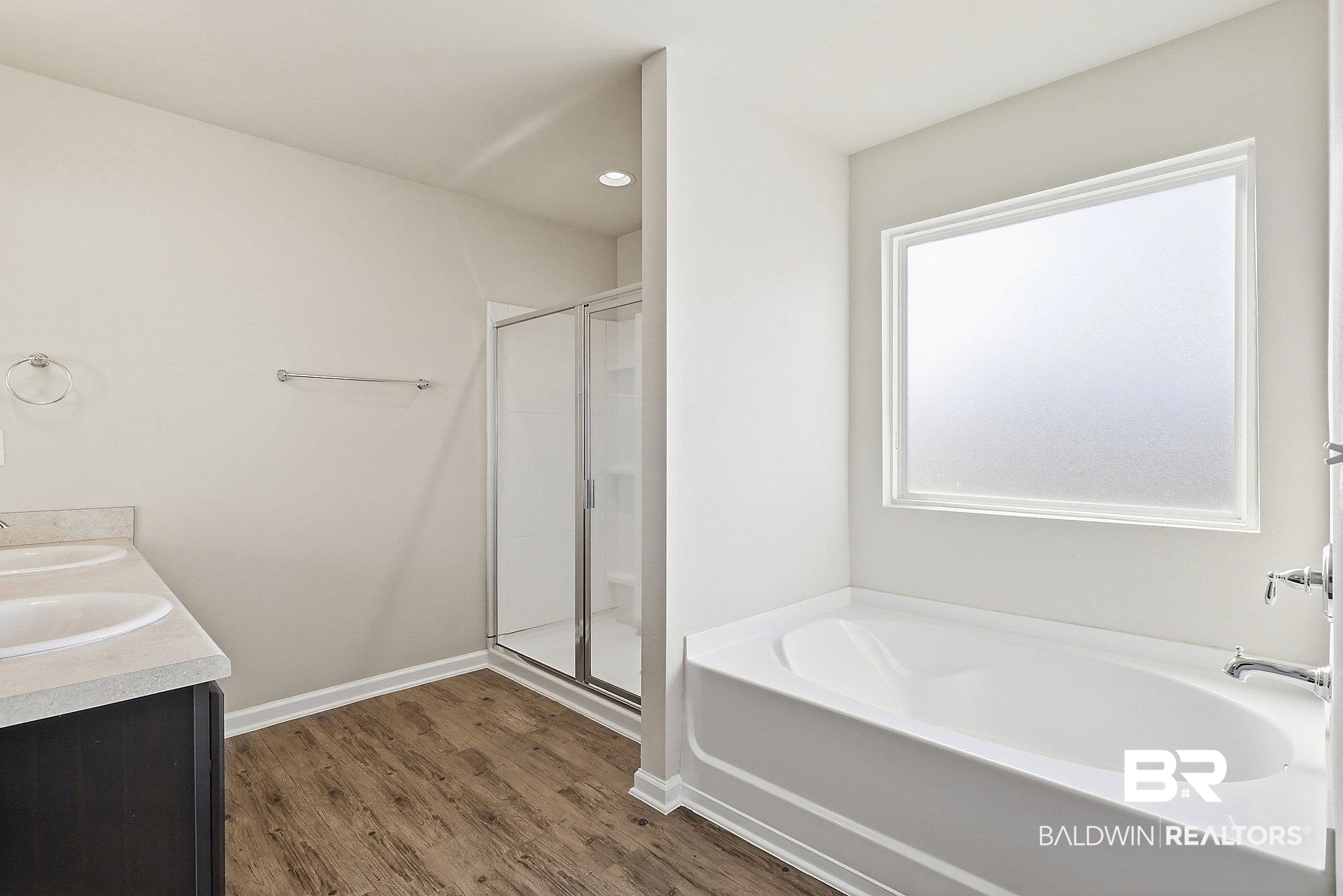 983 Summerton Drive Foley, AL 36535 - Photo 15 of 25 Full bathroom featuring a stall shower, double vanity, a garden tub, and dark wood-type flooring