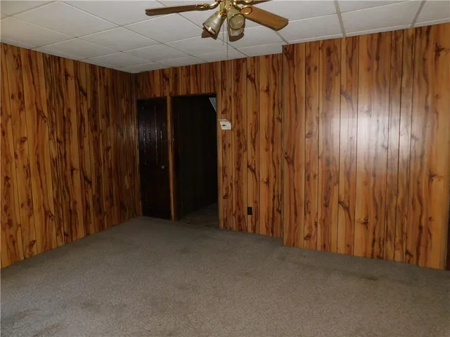 an empty room with a ceiling fan