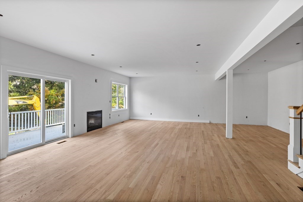 6 Nashoba Road Acton, MA 01720 - Photo 15 of 42 an empty room with wooden floor and windows