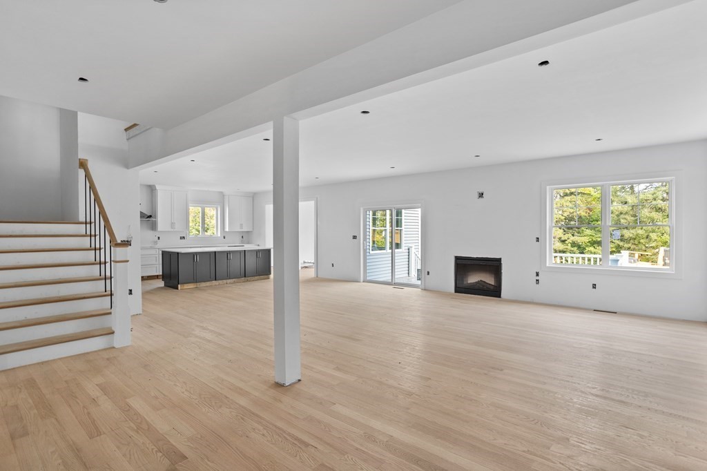 6 Nashoba Road Acton, MA 01720 - Photo 18 of 42 a view of an empty room with wooden floor fireplace and a window