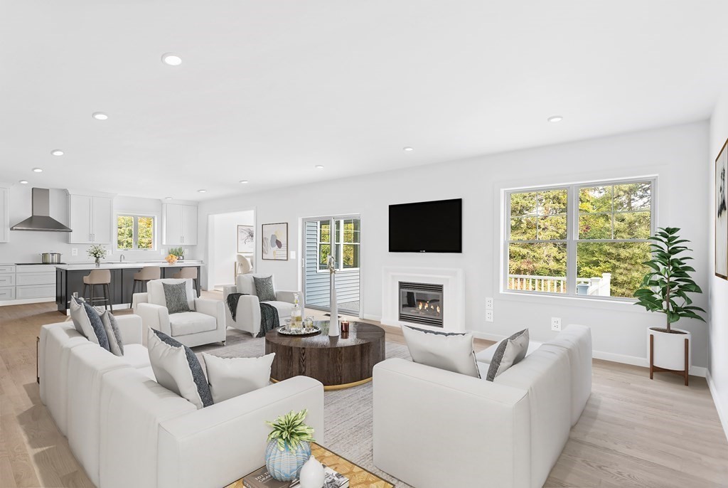 6 Nashoba Road Acton, MA 01720 - Photo 20 of 42 a living room with fireplace furniture and a flat screen tv