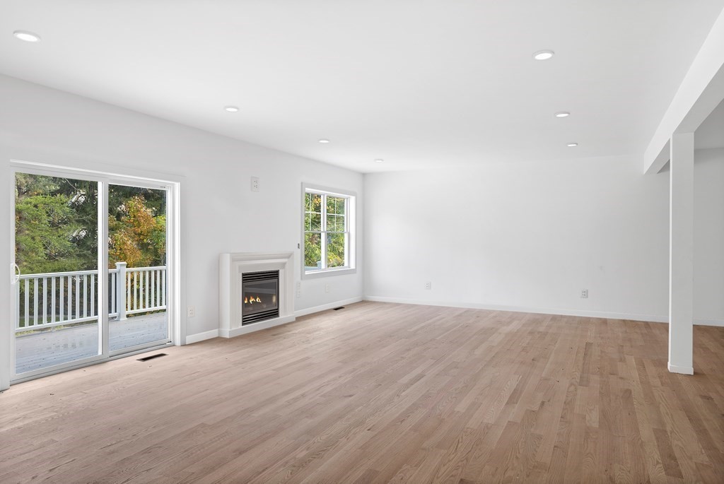 6 Nashoba Road Acton, MA 01720 - Photo 21 of 42 an empty room with windows and fireplace