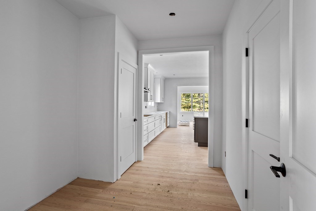 6 Nashoba Road Acton, MA 01720 - Photo 23 of 42 a view of a hallway with wooden floor front door