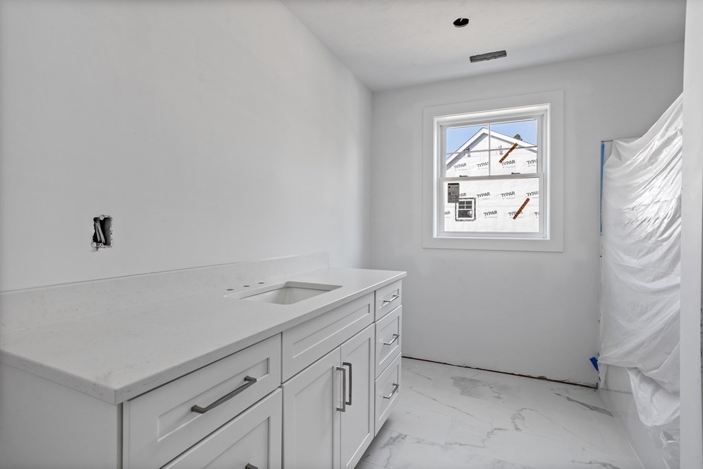 6 Nashoba Road Acton, MA 01720 - Photo 32 of 42 a utility room with cabinets washer and dryer