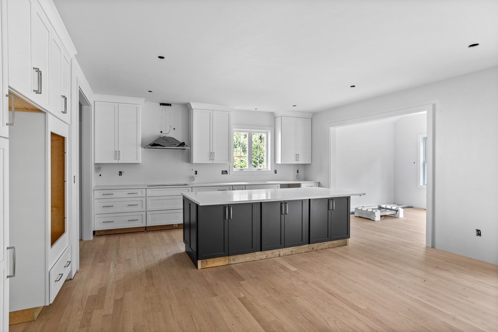 6 Nashoba Road Acton, MA 01720 - Photo 9 of 42 a kitchen with stainless steel appliances a refrigerator sink and white cabinets