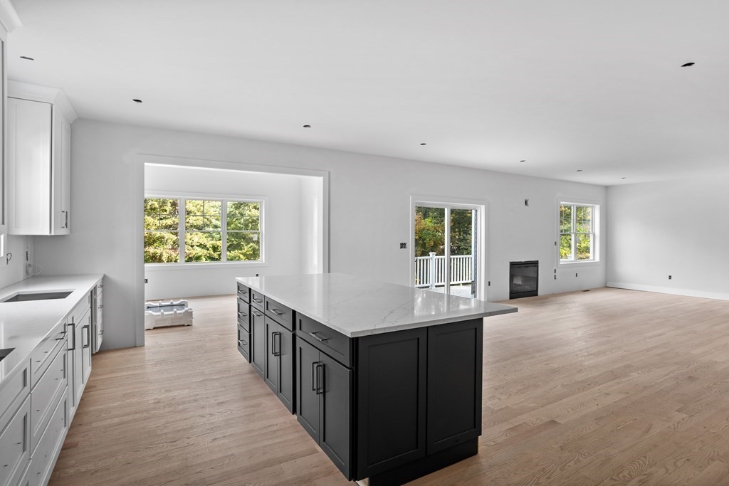 6 Nashoba Road Acton, MA 01720 - Photo 10 of 42 a kitchen with kitchen island a sink a counter top space and a window