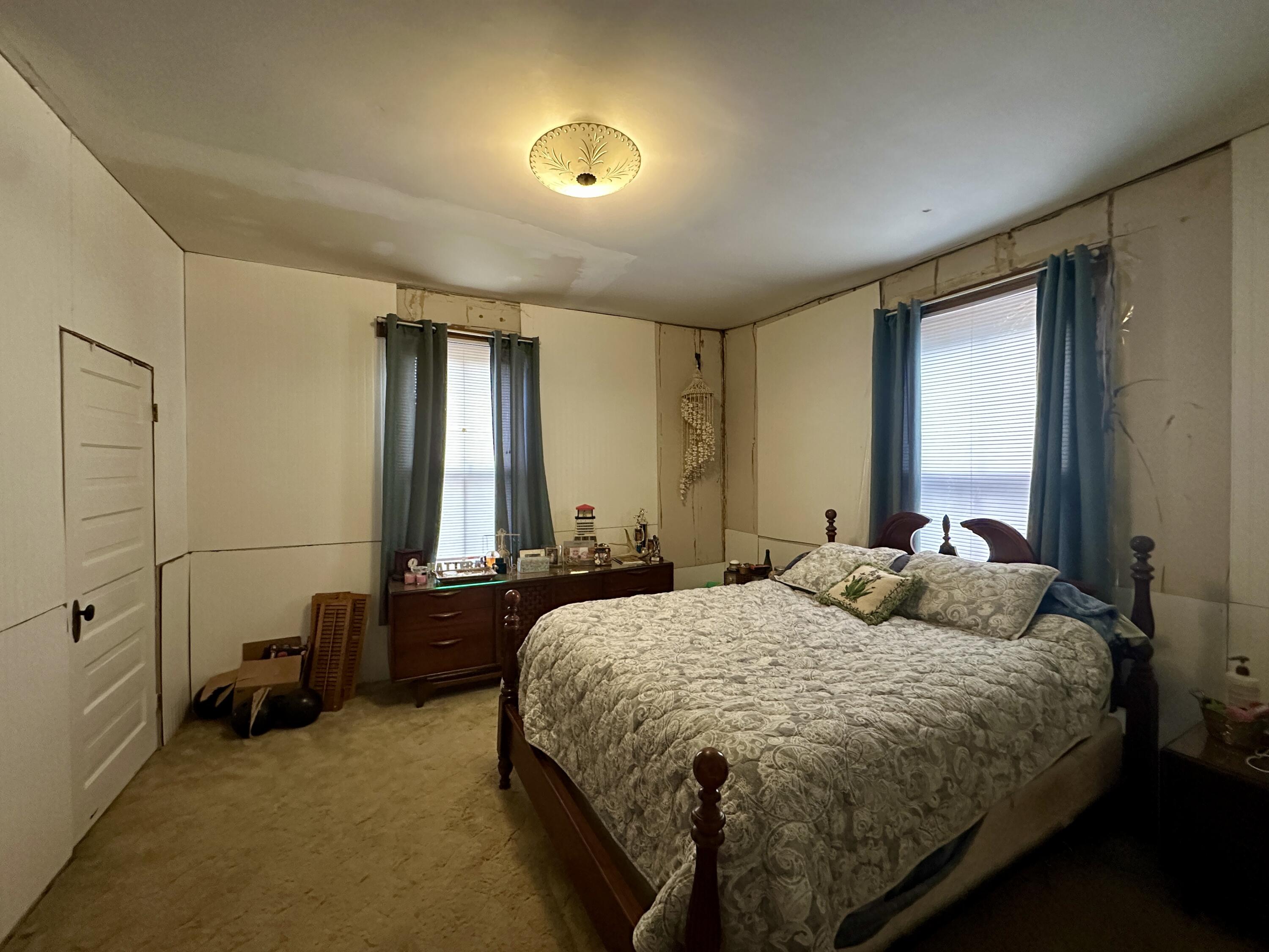 60 Soapstone Road Ridgeway, VA 24148 - Photo 11 of 26 a bedroom with a bed and a chandelier