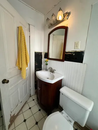 a bathroom with a sink toilet and mirror