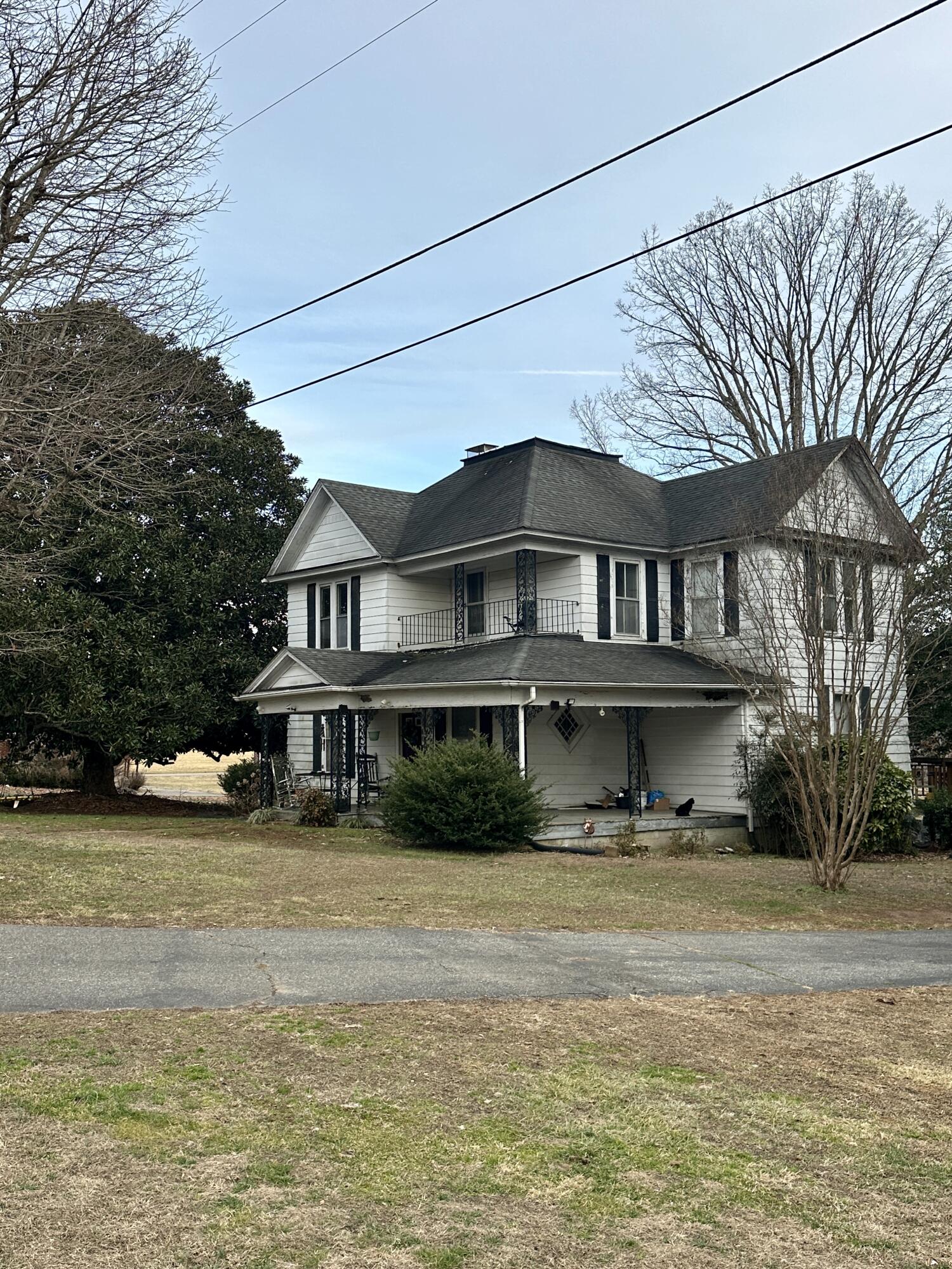 60 Soapstone Road Ridgeway, VA 24148 - Photo 2 of 26 a big white house with a large pool lawn and large trees