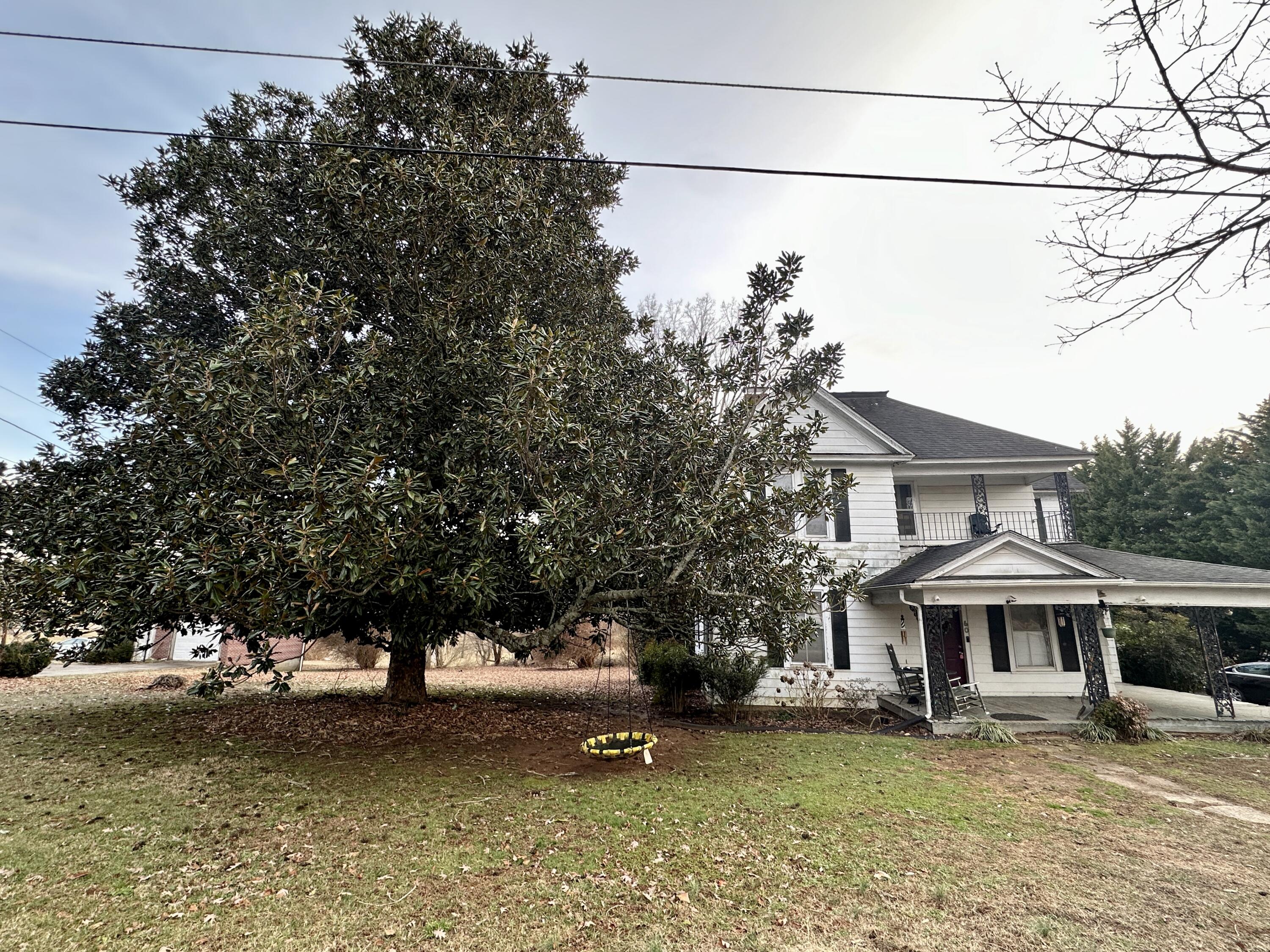 60 Soapstone Road Ridgeway, VA 24148 - Photo 24 of 26 a view of a white house with a large tree and a yard