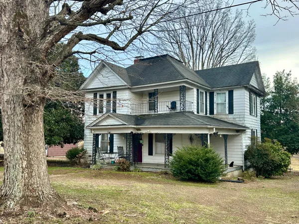 a front view of a house with yard and green space