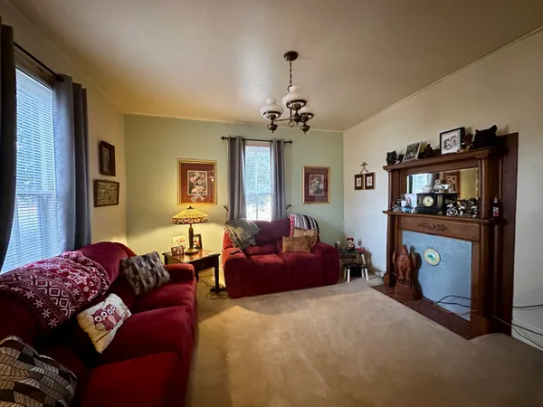 a living room with furniture a window and a chandelier