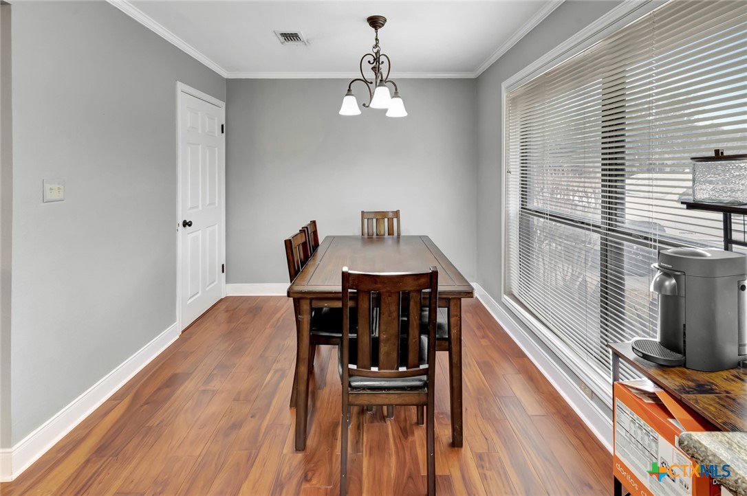101 Kemble Street Victoria, TX 77904 - Photo 11 of 34 a view of a dining room with furniture window and wooden floor