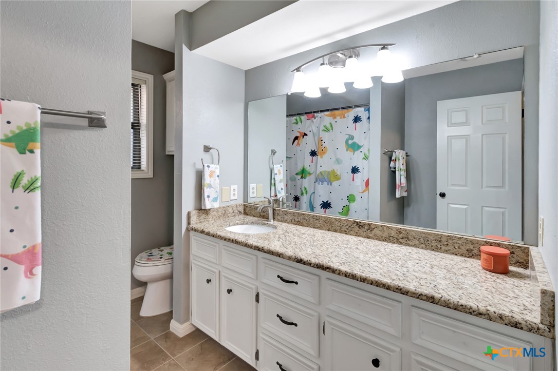 101 Kemble Street Victoria, TX 77904 - Photo 20 of 34 a bathroom with a granite countertop double vanity sink and a mirror
