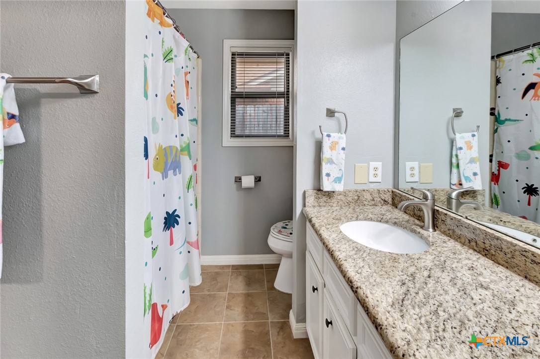 101 Kemble Street Victoria, TX 77904 - Photo 21 of 34 a spacious bathroom with a granite countertop tub sink and a mirror