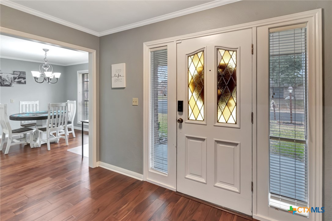 101 Kemble Street Victoria, TX 77904 - Photo 3 of 34 a view of a hallway with wooden floor windows and a dining room