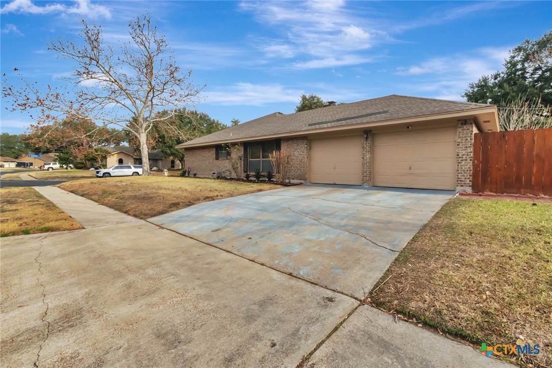 101 Kemble Street Victoria, TX 77904 - Photo 31 of 34 a front view of a house with a yard and garage