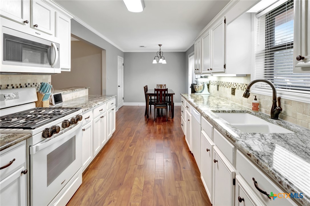 101 Kemble Street Victoria, TX 77904 - Photo 6 of 34 a large kitchen with stainless steel appliances granite countertop a stove and a sink