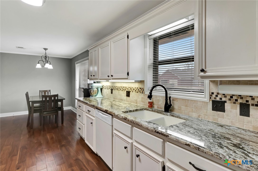 101 Kemble Street Victoria, TX 77904 - Photo 7 of 34 a kitchen with granite countertop a sink a stove and cabinets