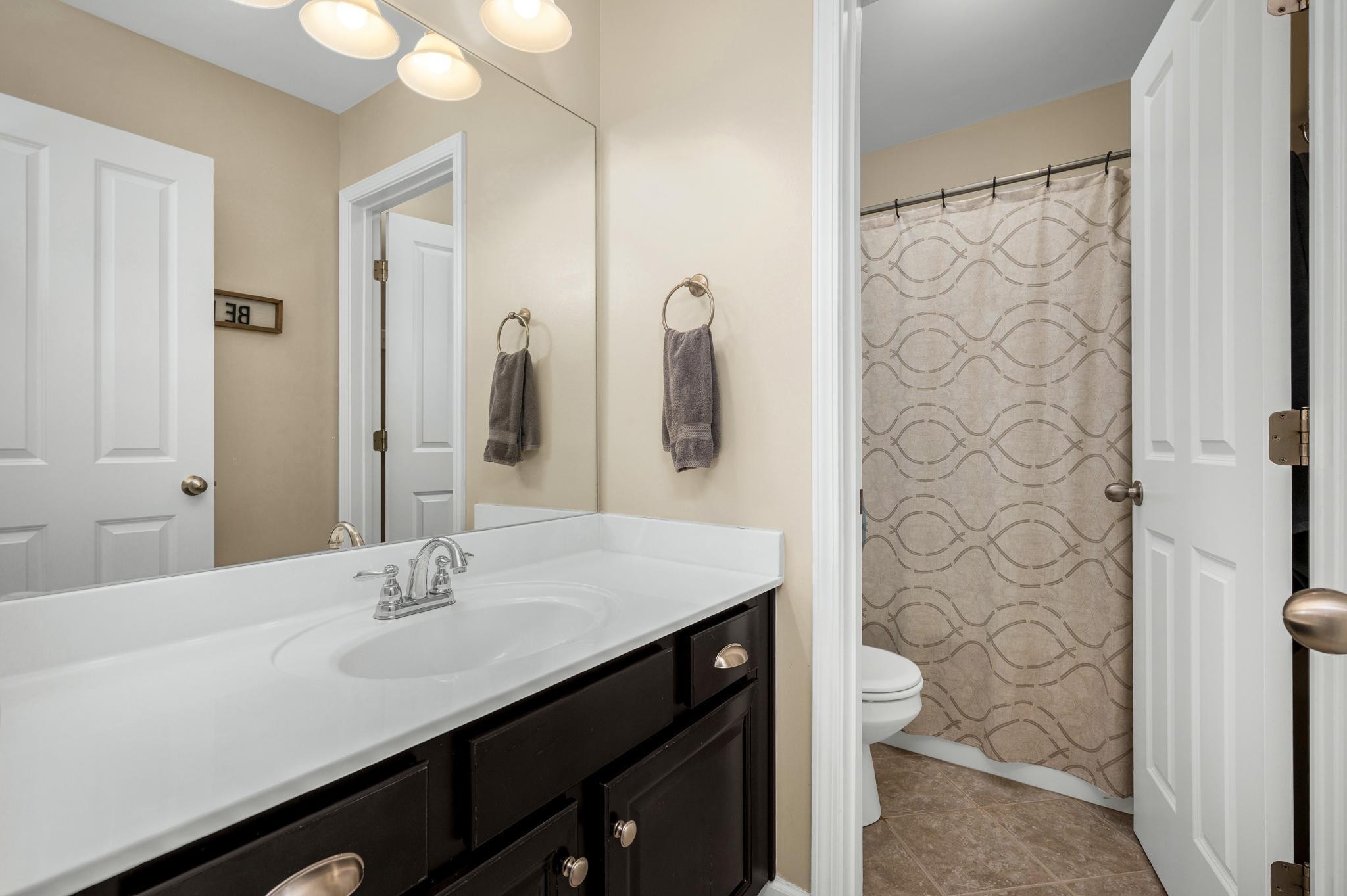 5003 Hemlock Court Spring Hill, TN 37174 - Photo 23 of 32 a bathroom with a sink a toilet and shower
