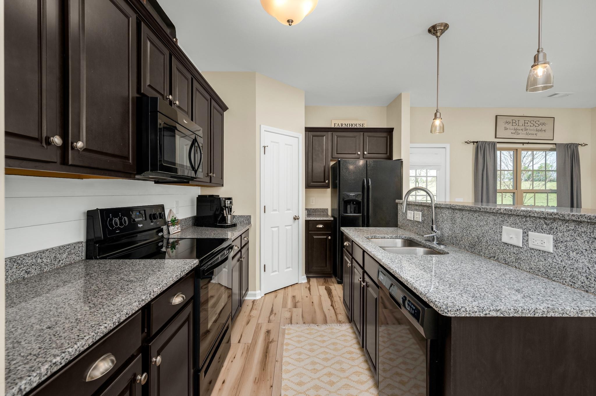 5003 Hemlock Court Spring Hill, TN 37174 - Photo 6 of 32 a kitchen with stainless steel appliances granite countertop a sink stove and refrigerator