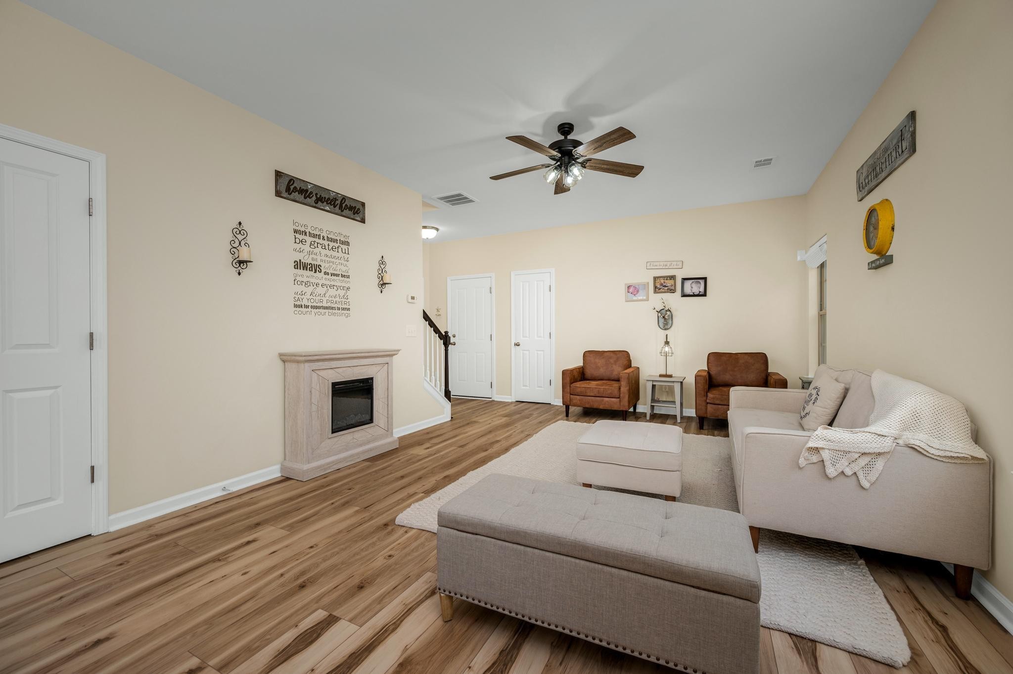 5003 Hemlock Court Spring Hill, TN 37174 - Photo 8 of 32 a living room with furniture a fireplace and a flat screen tv
