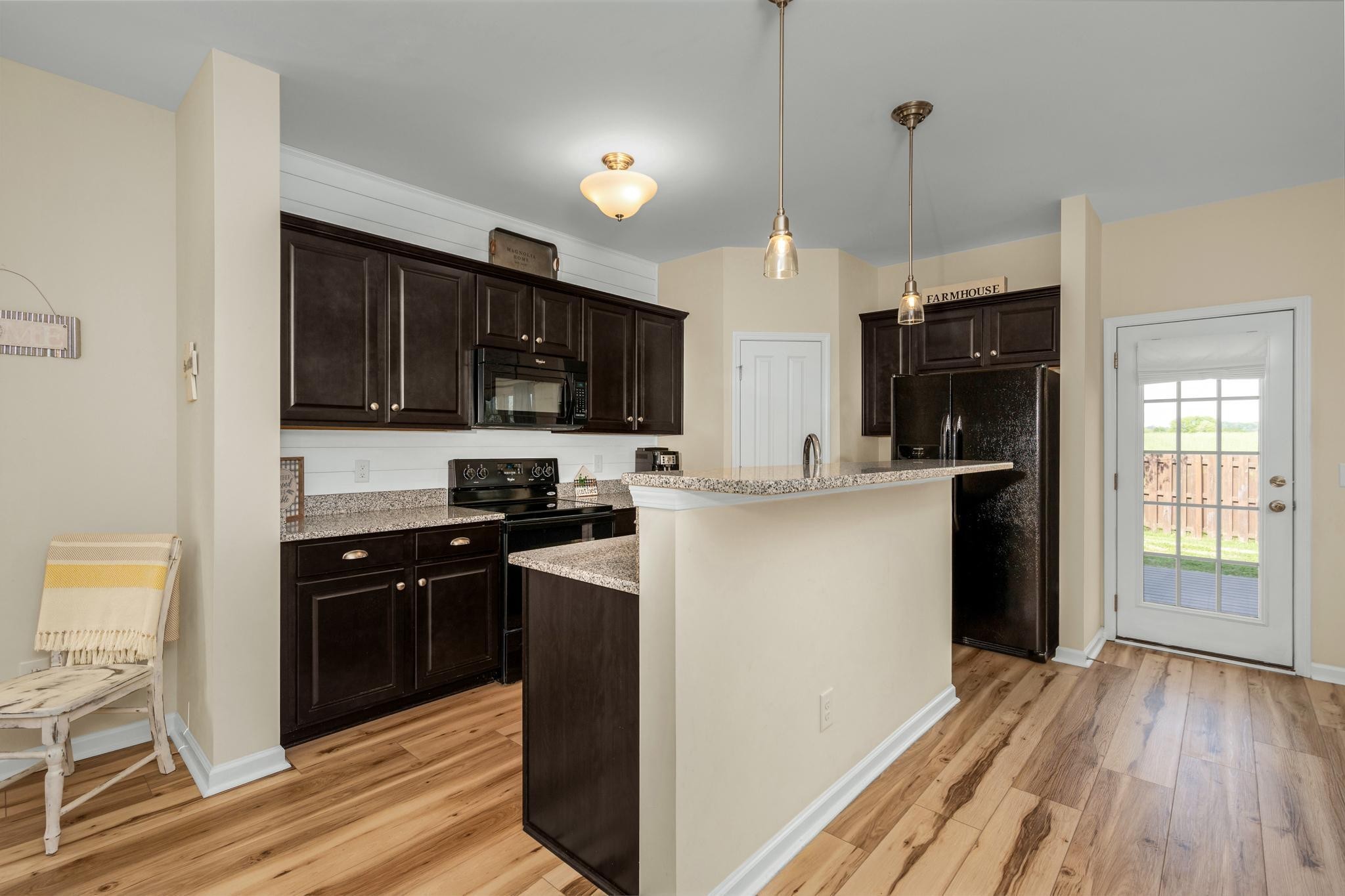 5003 Hemlock Court Spring Hill, TN 37174 - Photo 10 of 32 a kitchen with stainless steel appliances granite countertop a refrigerator a stove top oven a sink dishwasher and white cabinets with wooden floor