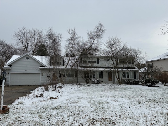 a view of a yard covered with snow in front of house