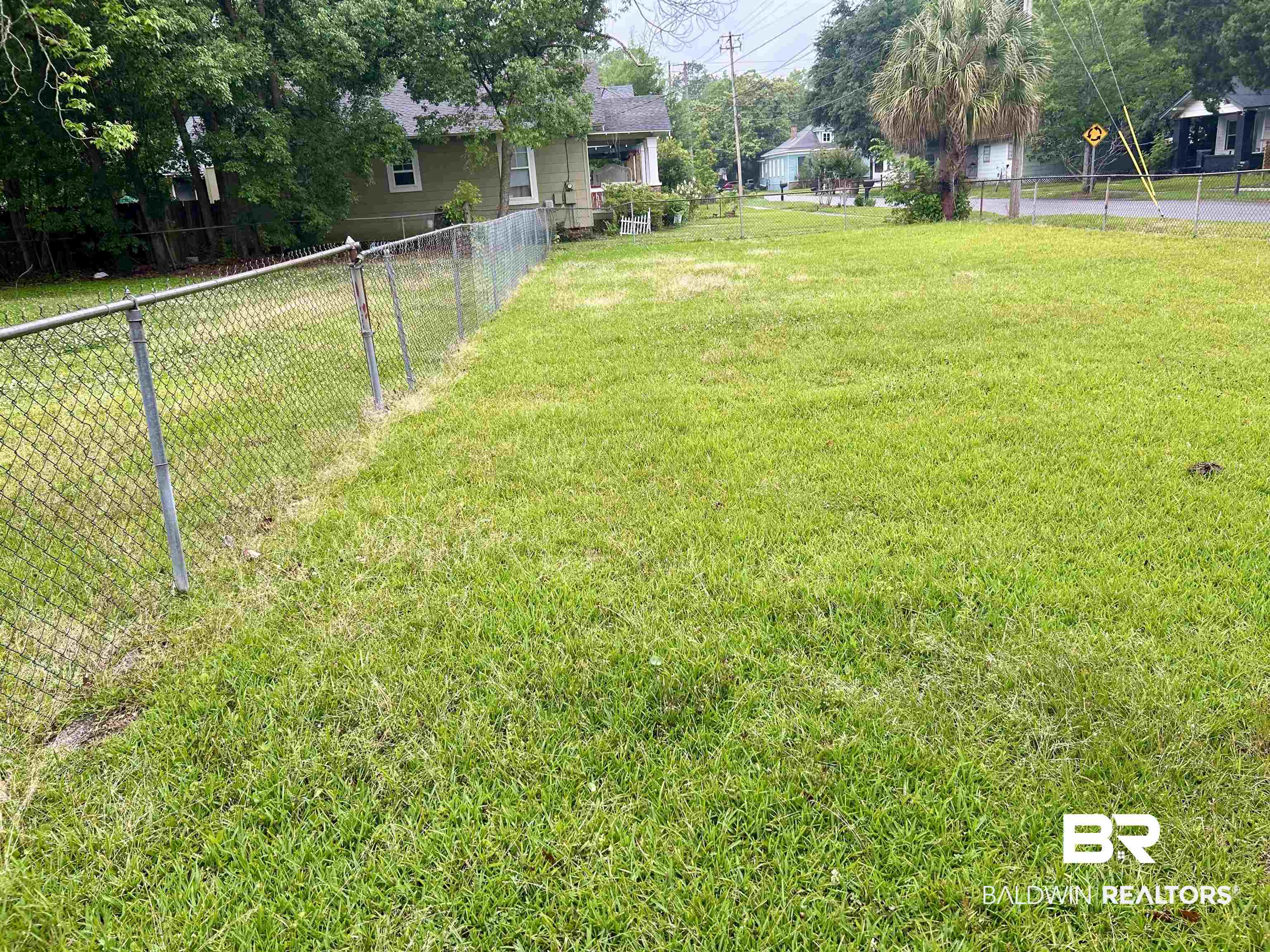 302 Stocking Street Mobile, AL 36604 - Photo 7 of 31 Generous grassy lot featuring a chain-link fence