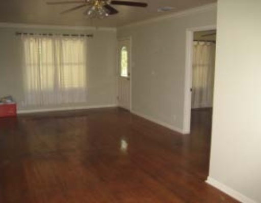 3929 Cott Street Corpus Christi, TX 78411 - Photo 2 of 10 an empty room with a window and a ceiling fan