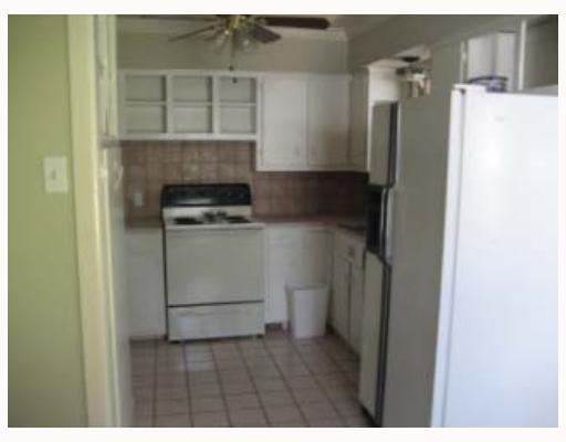 3929 Cott Street Corpus Christi, TX 78411 - Photo 4 of 10 a kitchen with a refrigerator and a stove