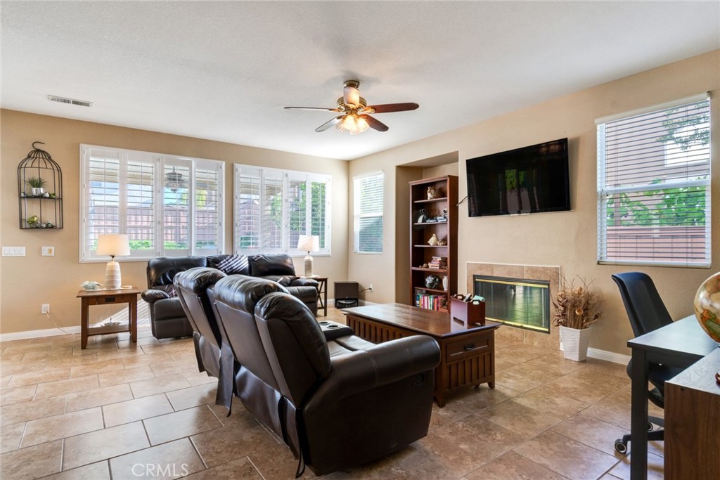 20885 Bakal Drive Riverside, CA 92508 - Photo 9 of 47 a living room with furniture a fireplace and a flat screen tv