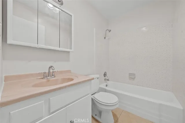 a bathroom with a sink a toilet and bathtub