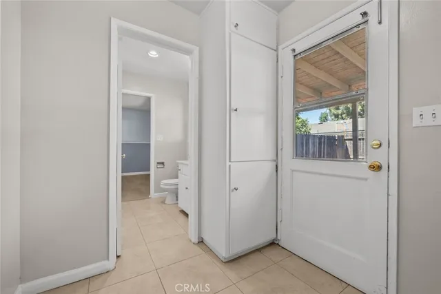 a view of a hallway with wooden cabinets and a floor to ceiling window