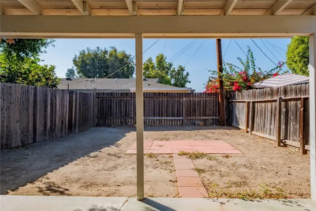 a view of a backyard with wooden fence