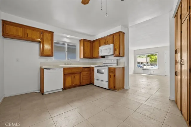 a kitchen with stainless steel appliances a stove a sink and a refrigerator