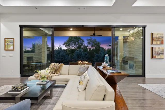 a living room with furniture and a floor to ceiling window