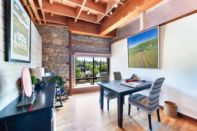 a dining room with furniture and wooden floor