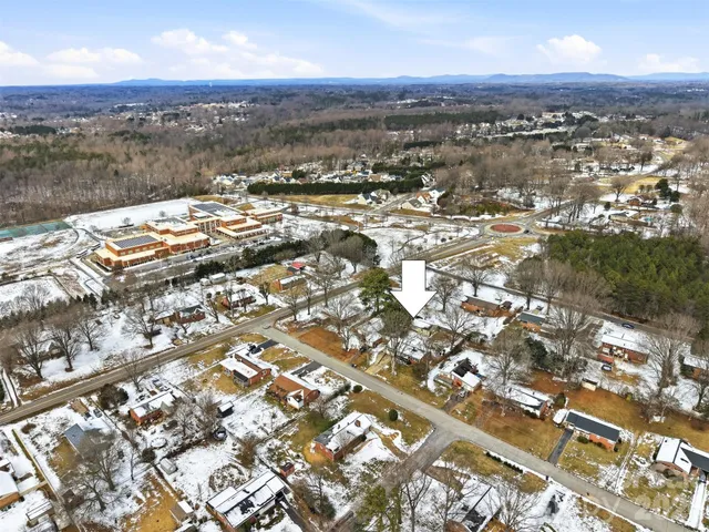 an aerial view of residential building with parking