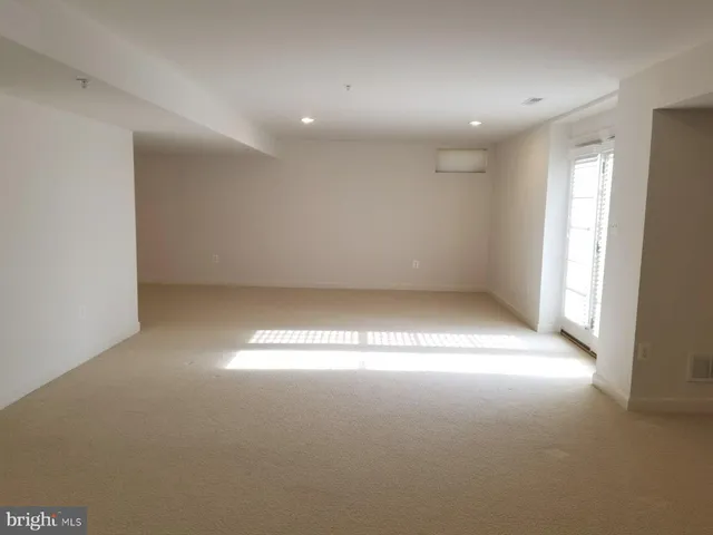 an empty room with a empty space and a window