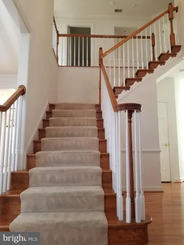 a view of entryway with wooden floor and front door