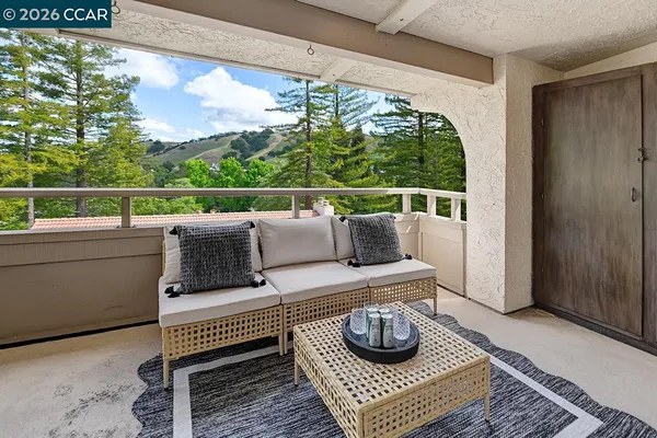 a living room with furniture and a floor to ceiling window