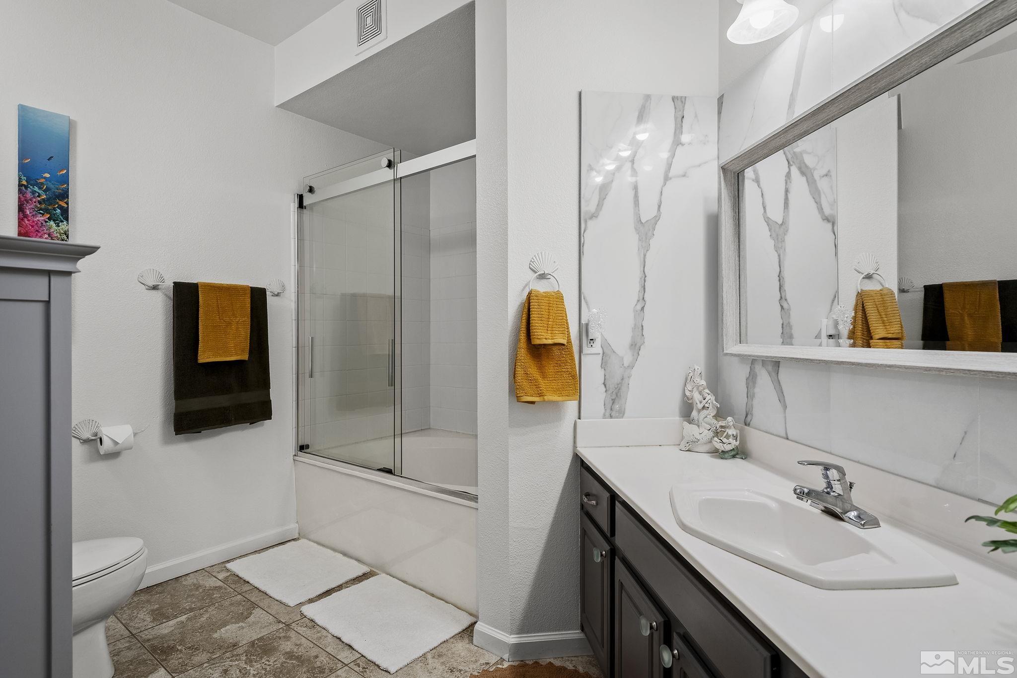900 South Meadows Parkway, Unit 2012 Reno, NV 89521 - Photo 11 of 17 a bathroom with a sink a toilet and shower