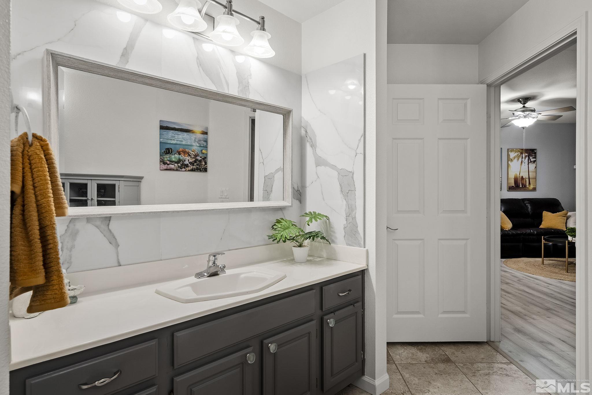900 South Meadows Parkway, Unit 2012 Reno, NV 89521 - Photo 12 of 17 a bathroom with a sink and a mirror