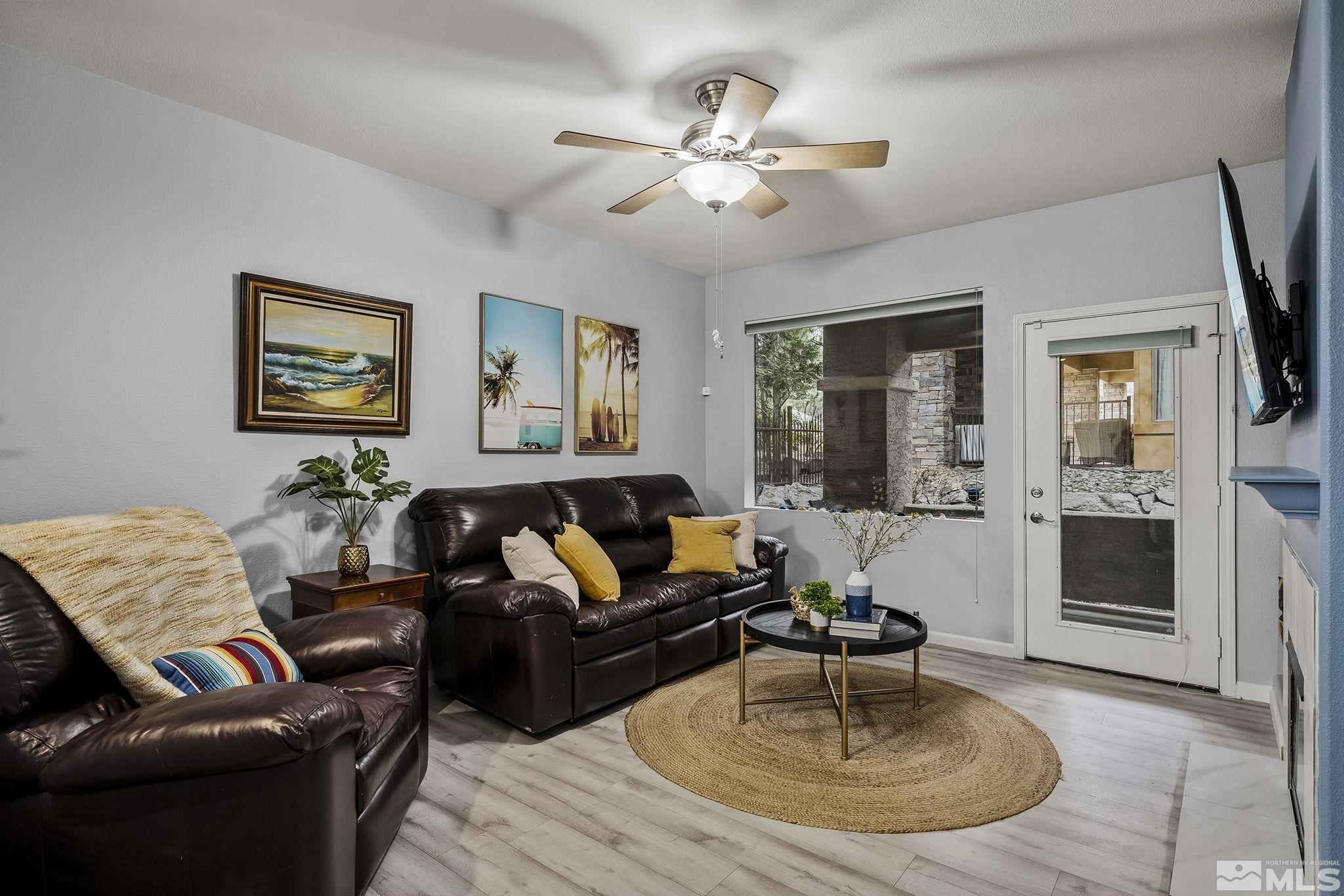 900 South Meadows Parkway, Unit 2012 Reno, NV 89521 - Photo 2 of 17 a living room with furniture and a fireplace