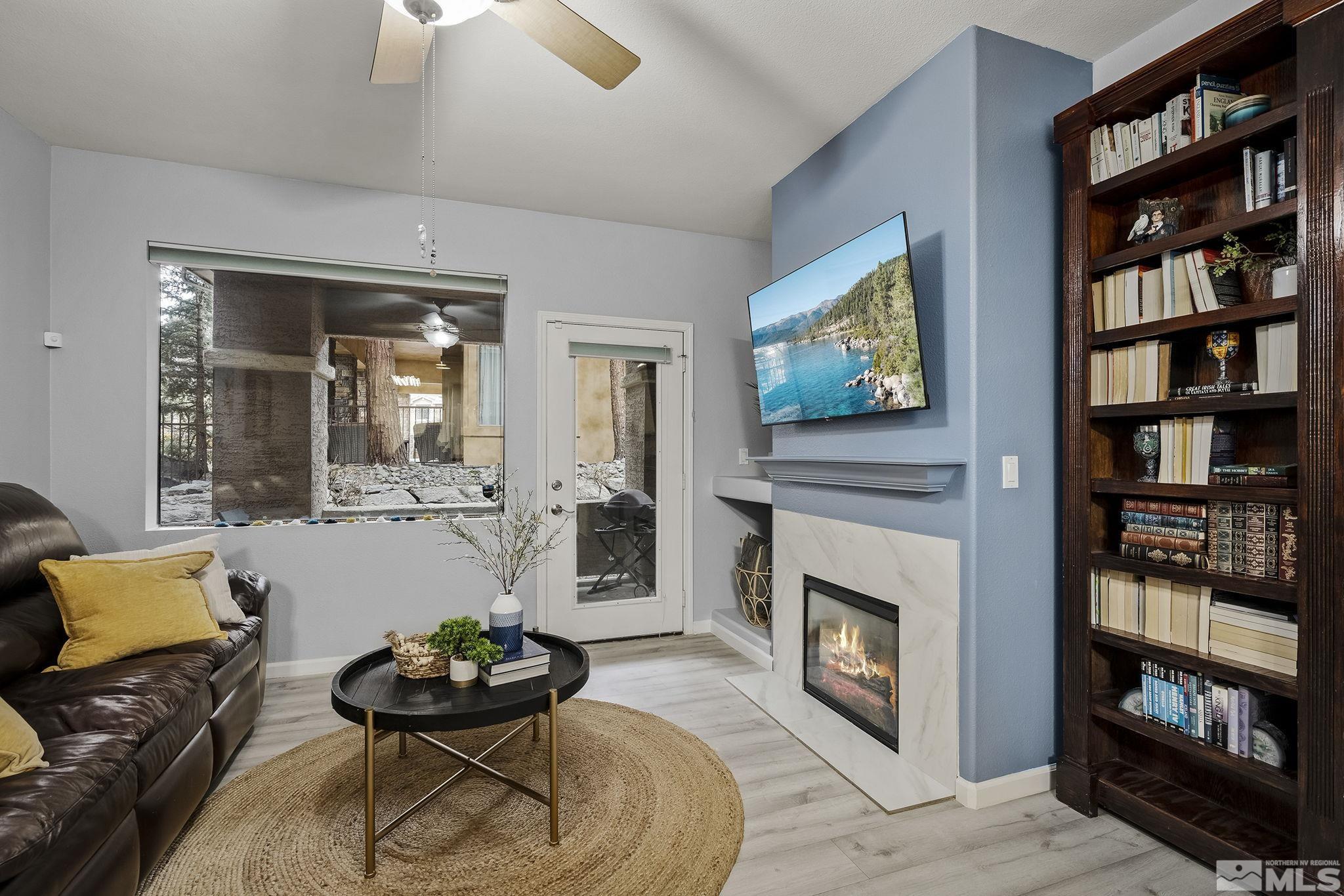 900 South Meadows Parkway, Unit 2012 Reno, NV 89521 - Photo 3 of 17 a living room with furniture and a fireplace